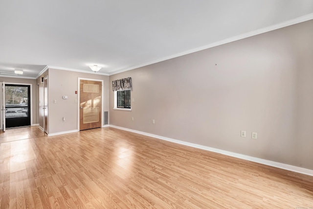 unfurnished living room with crown molding and light hardwood / wood-style floors