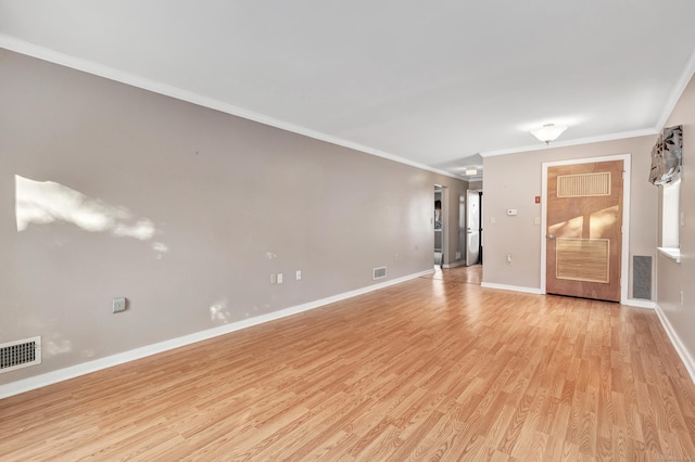 unfurnished living room featuring light hardwood / wood-style flooring and crown molding