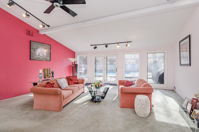 carpeted living room with ceiling fan, lofted ceiling with beams, and rail lighting