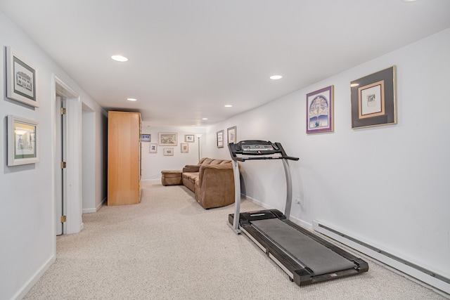 exercise area featuring a baseboard radiator and light colored carpet