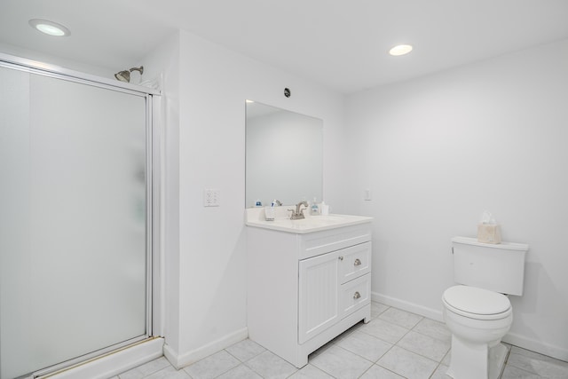 bathroom featuring toilet, tile patterned floors, a shower with shower door, and vanity