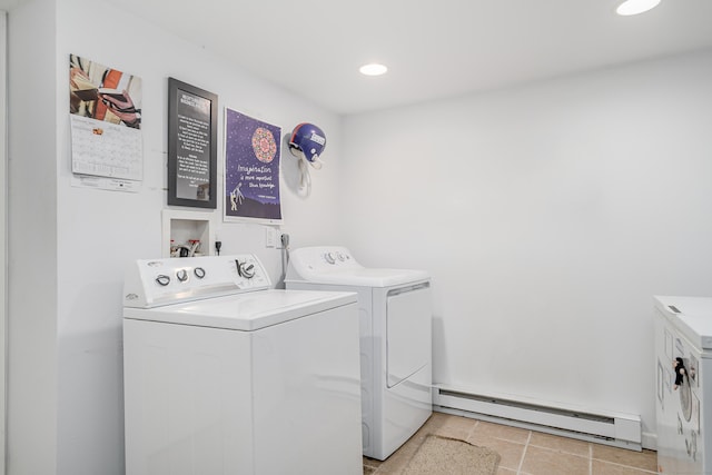 clothes washing area featuring washer and dryer and a baseboard heating unit