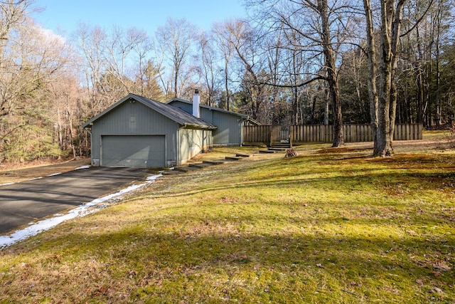 view of property exterior featuring a garage and a yard