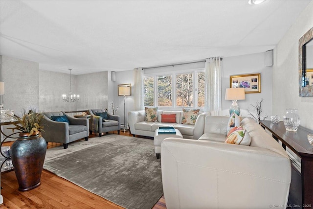 living room with wood-type flooring and a notable chandelier