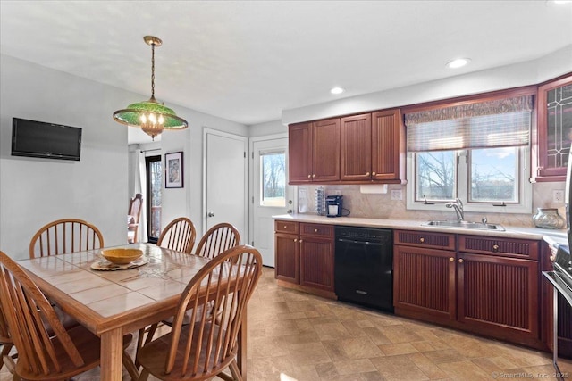 kitchen with sink, pendant lighting, decorative backsplash, and dishwasher