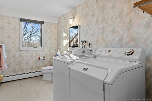 laundry room with a baseboard heating unit and separate washer and dryer