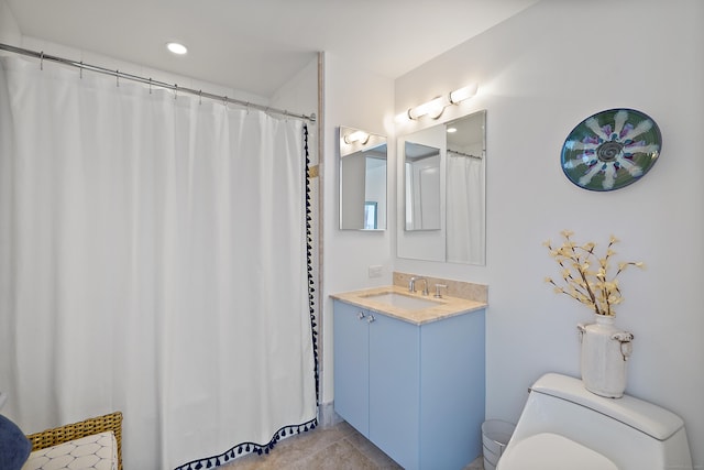 bathroom featuring toilet, tile patterned floors, and vanity