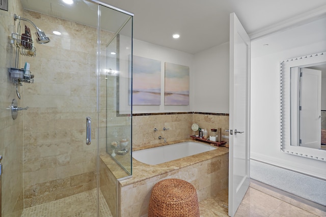 bathroom with tile patterned flooring and shower with separate bathtub