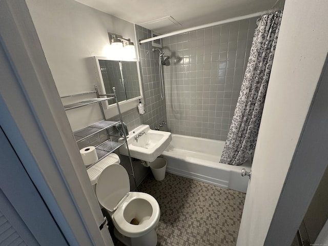 bathroom with shower / tub combo with curtain and toilet