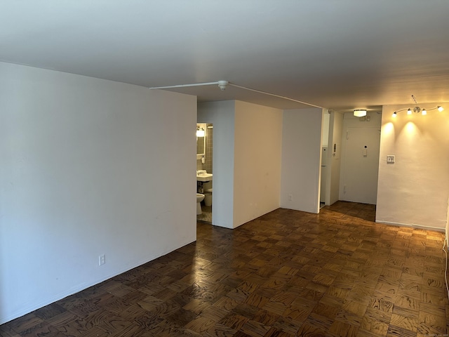 unfurnished room with dark parquet floors