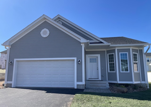 view of front of home featuring a garage and a front yard