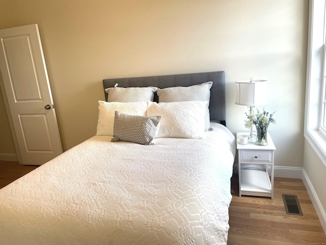 bedroom with hardwood / wood-style flooring