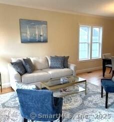 145 Webster Ln Unit 2-41, Middletown, CT 06457 - living area featuring baseboards, ornamental molding, and wood finished floors