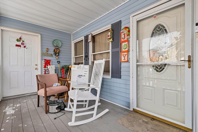 view of exterior entry with covered porch