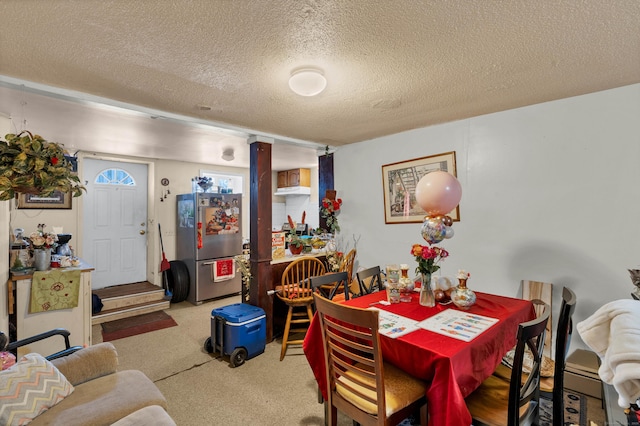 dining area featuring a textured ceiling