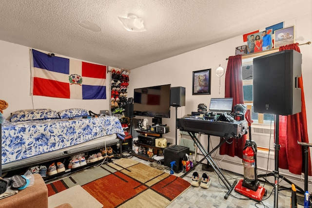 bedroom featuring multiple windows and a textured ceiling