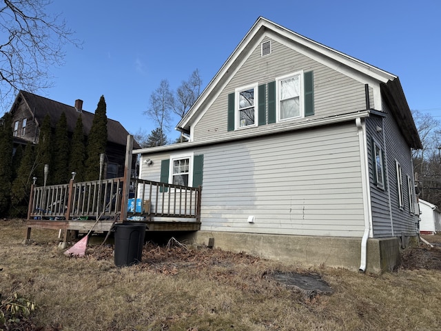 back of house with a wooden deck