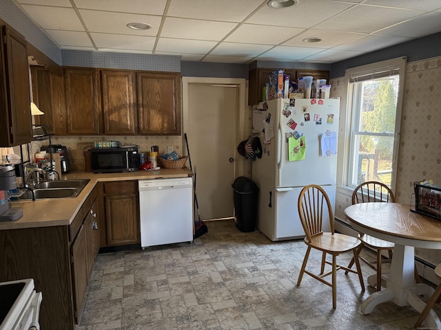 kitchen with sink, white appliances, and a paneled ceiling