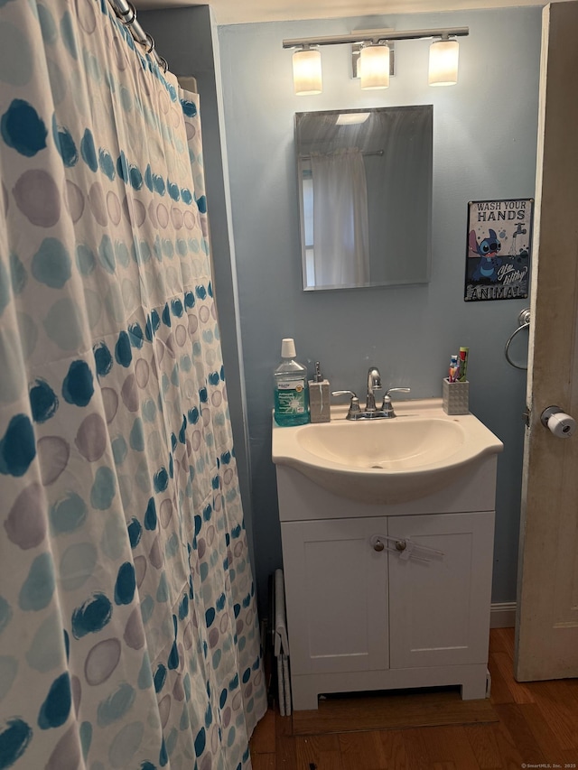 bathroom featuring hardwood / wood-style floors, vanity, and a shower with shower curtain