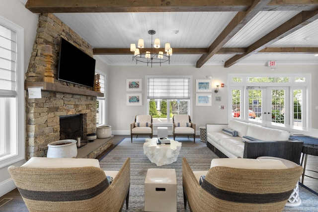 living room with beam ceiling, a healthy amount of sunlight, and an inviting chandelier