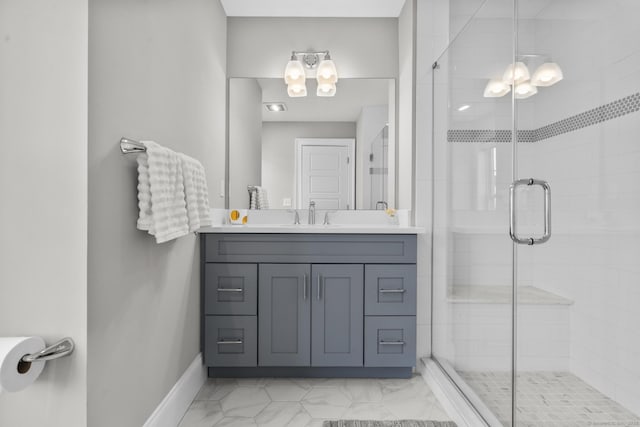 bathroom featuring a shower with shower door and vanity