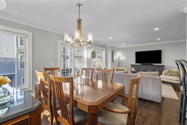 dining room featuring dark hardwood / wood-style flooring, ornamental molding, and an inviting chandelier