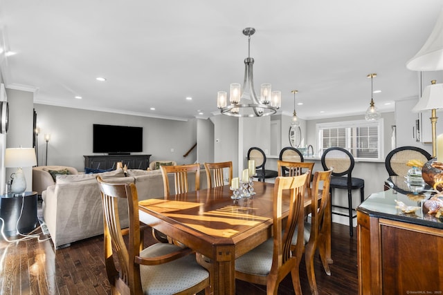 dining area featuring dark hardwood / wood-style floors, a chandelier, and ornamental molding