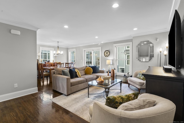 living room with plenty of natural light, crown molding, a chandelier, and dark hardwood / wood-style floors