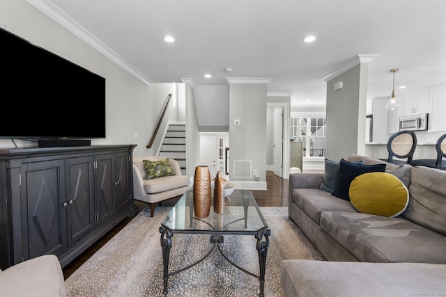 living room with wood-type flooring and ornamental molding