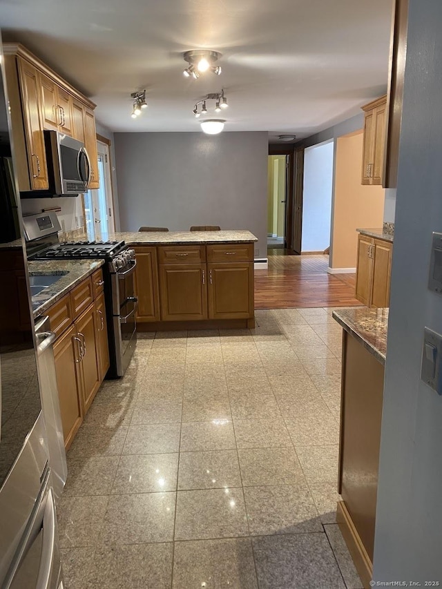 kitchen with stainless steel appliances and kitchen peninsula