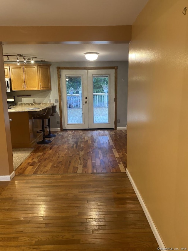 doorway to outside with dark hardwood / wood-style flooring and french doors