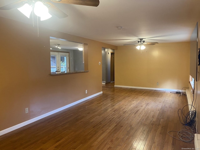 empty room featuring ceiling fan, hardwood / wood-style floors, and french doors