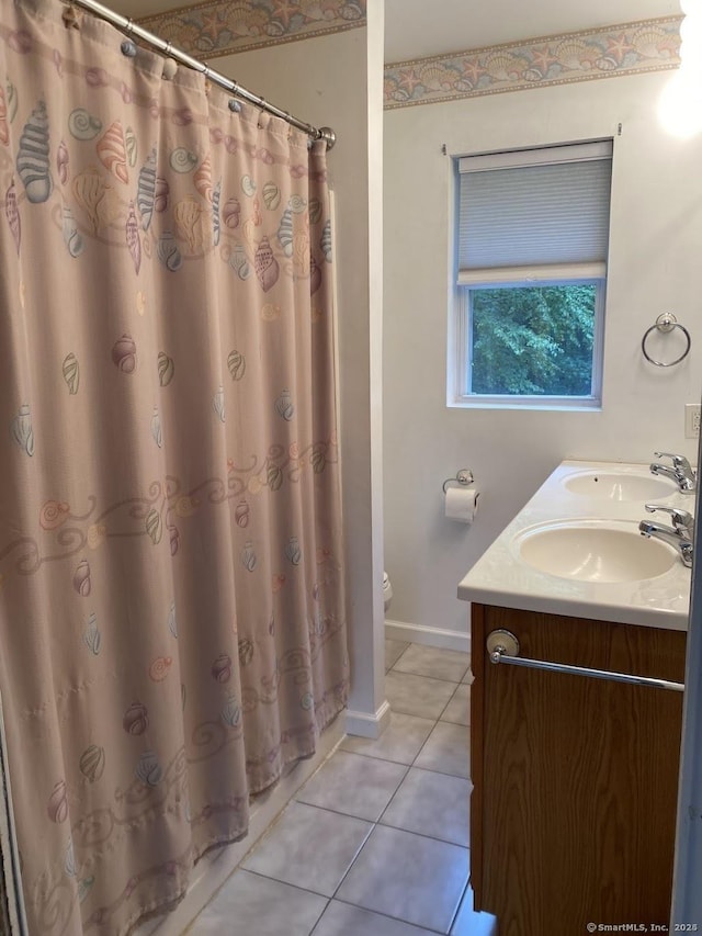 bathroom featuring curtained shower, tile patterned floors, vanity, and toilet