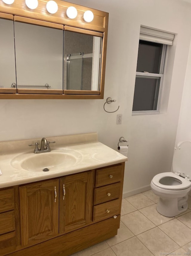 bathroom with tile patterned floors, vanity, and toilet