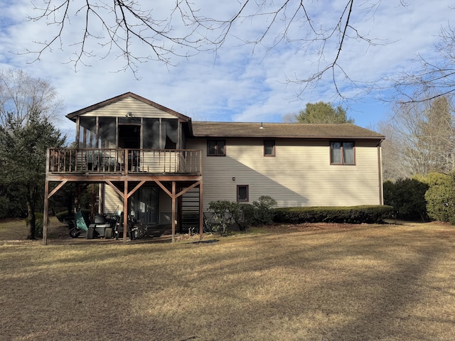 rear view of property featuring a wooden deck and a sunroom