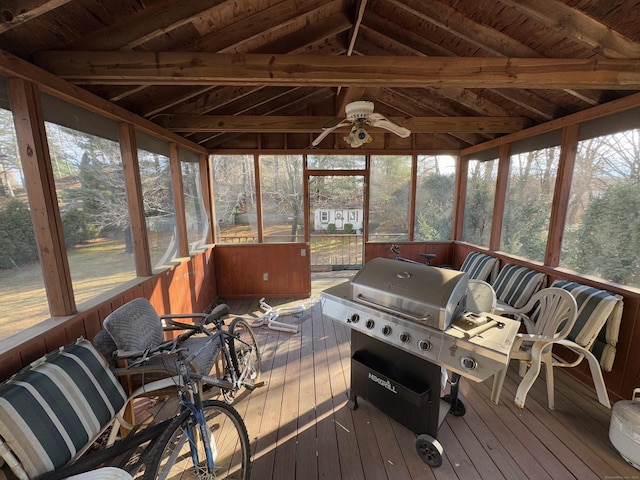 sunroom / solarium featuring ceiling fan, a healthy amount of sunlight, and lofted ceiling