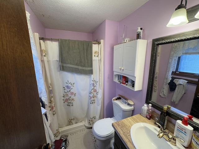 bathroom featuring toilet, vanity, a shower with shower curtain, and a textured ceiling