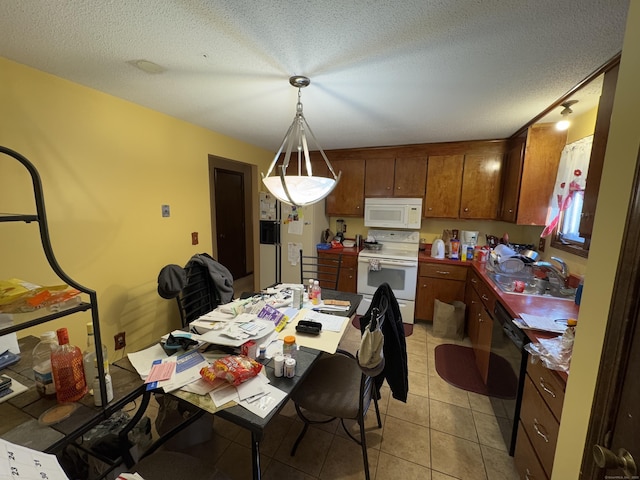 tiled dining room with sink and a textured ceiling