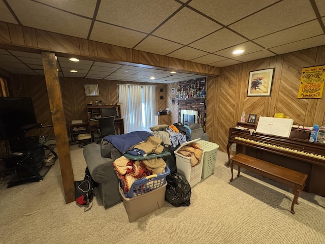 interior space featuring carpet floors, a fireplace, and wooden walls