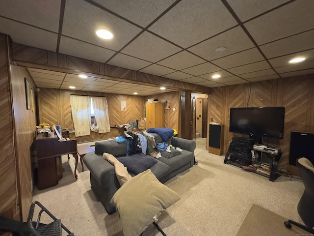 carpeted living room with wood walls