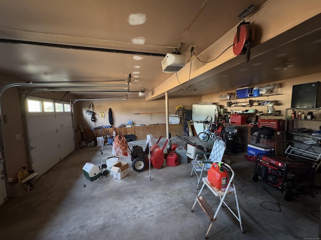 garage featuring a garage door opener and a workshop area