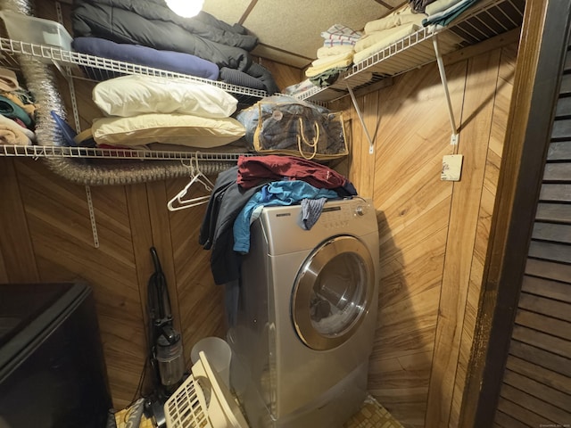 washroom featuring wood walls and washer / dryer