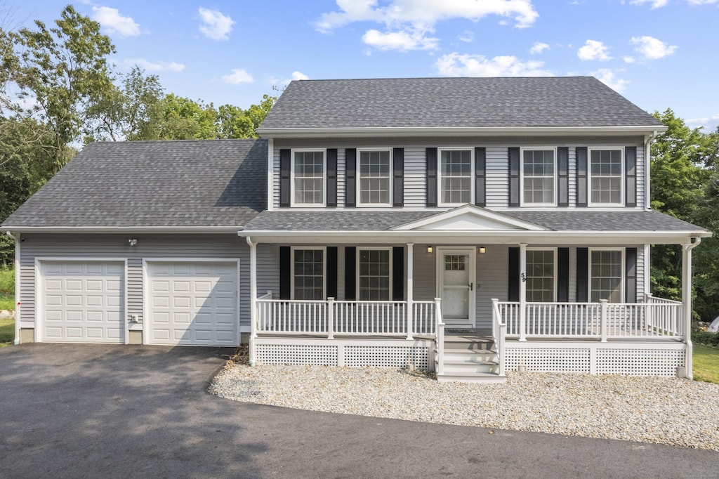 view of front facade with a porch and a garage