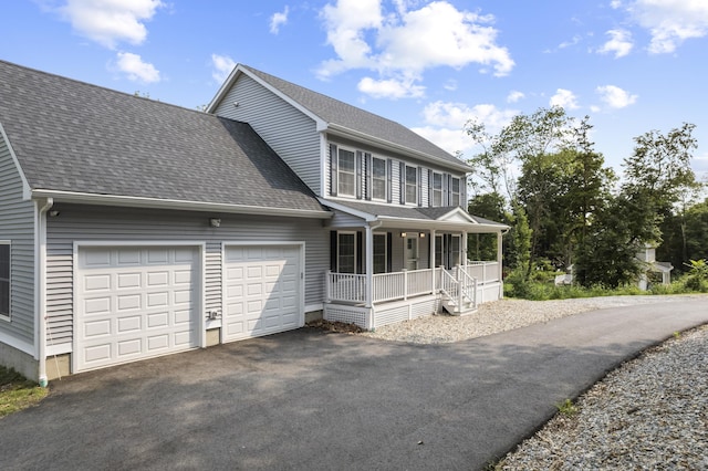 view of front of property featuring covered porch and a garage