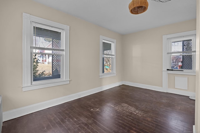 spare room with dark hardwood / wood-style floors