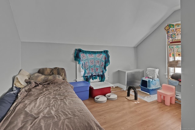 bedroom featuring hardwood / wood-style flooring and lofted ceiling