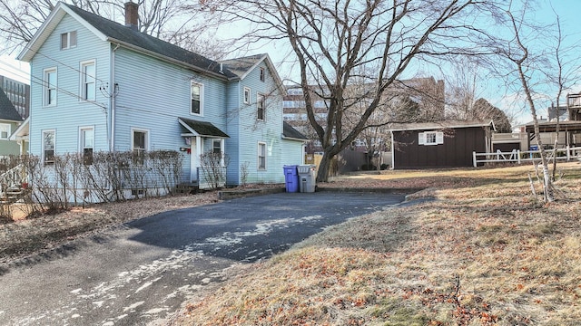 view of side of property with a storage shed