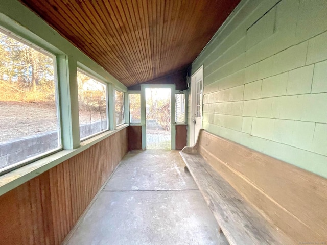 unfurnished sunroom with wood ceiling and vaulted ceiling