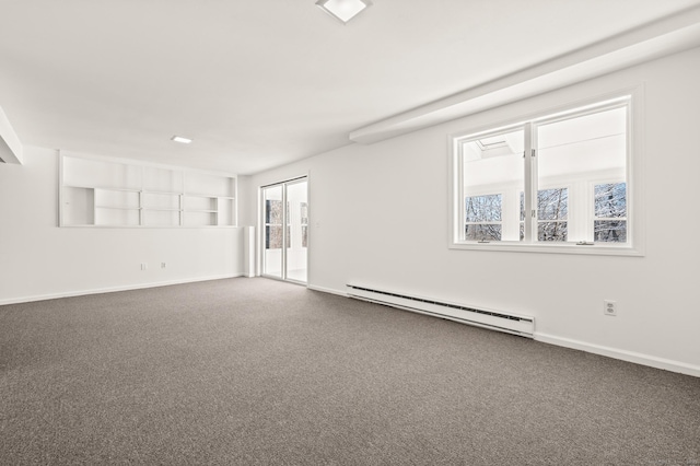 empty room with carpet floors and baseboard heating