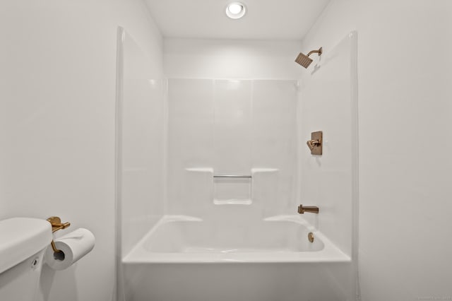 bathroom featuring shower / bathtub combination and toilet